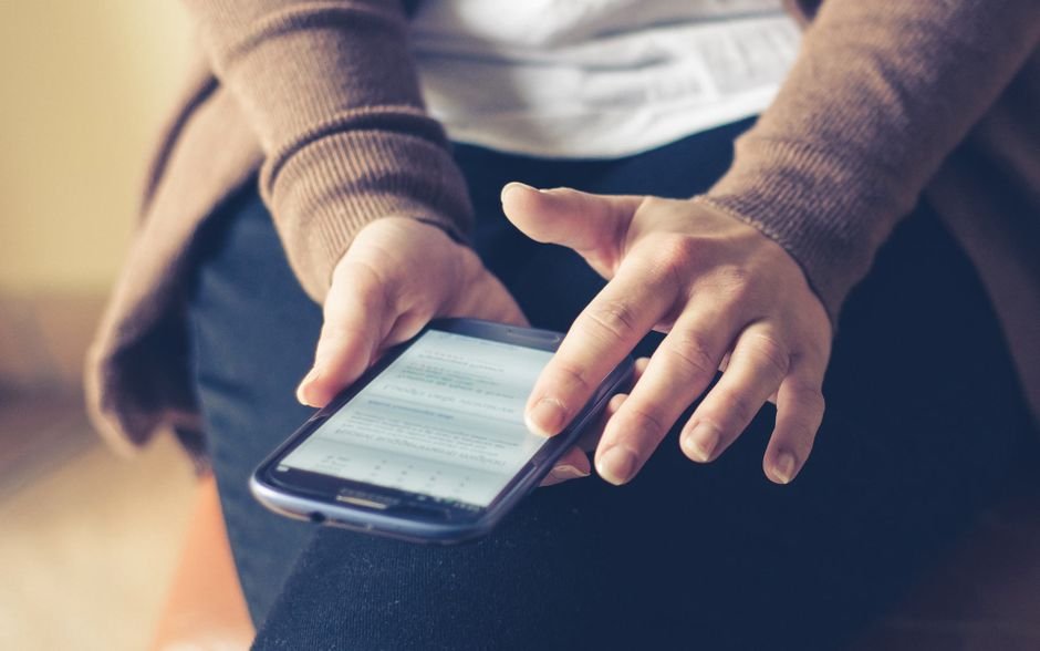 person filling online questionnaire phone
