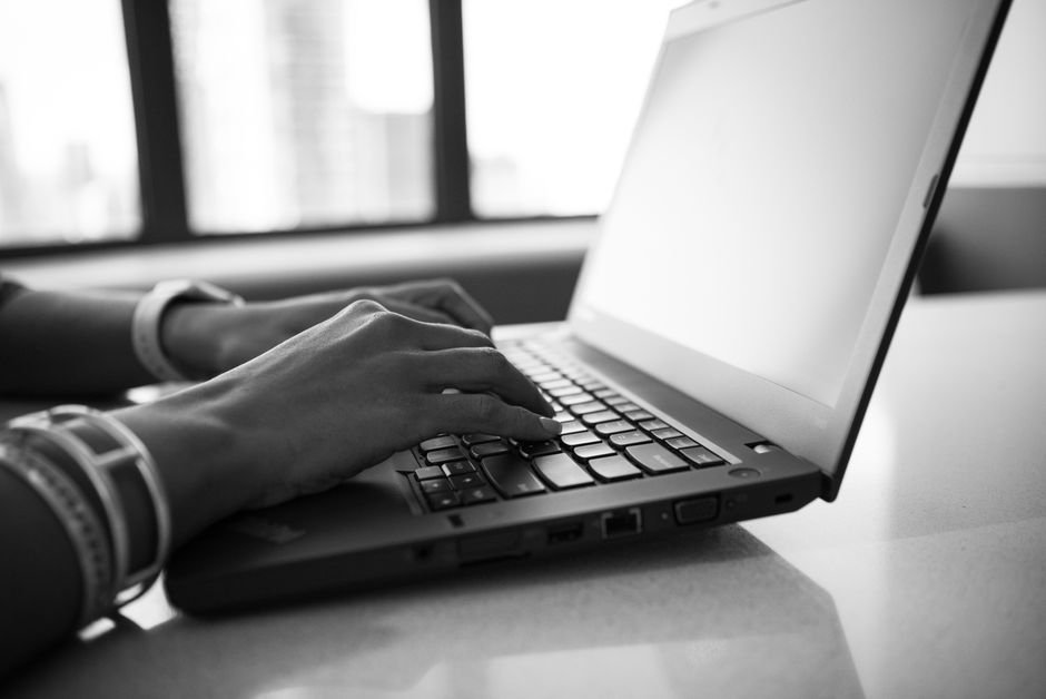 hands typing on laptop